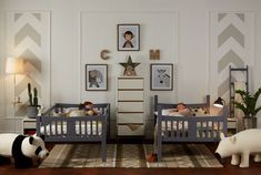 two children's beds with stuffed animals on them in a white and gray room