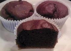 three chocolate cupcakes sitting on top of a white plate