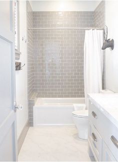 a bathroom with a toilet, bathtub and sink