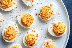 deviled eggs on a plate with mustard spread