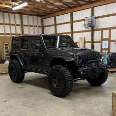 a black jeep is parked in a garage