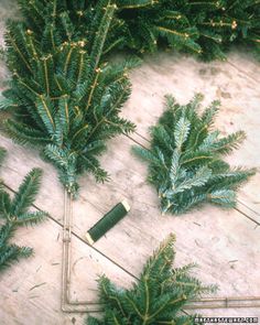 christmas wreaths and candles are arranged on the floor next to each other, including one with a green candle