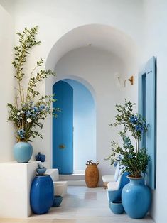 blue and white vases are on the floor in this hallway