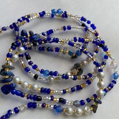 This handmade waist bead is made with a mix of blue clear, gold seed beads size 8/0 and it has lapis lazuli crystals and imitated Swarovski crystals, all spiritually mixed together with white 6 mm pearl glass beads. Waist Bead will fit up to 50 inches  You can choose  premium stretch cord for removable or nylon string or Wire for permanent. If you add a clasp please include your Waist Size in the personalization section at checkout or leave me a message. Your beads will default to 50 inches and Waist Bead Pattern Ideas, Waist Bead Patterns, Blue Spacer Beads Bracelets For Festivals, Blue Festival Bracelets With Spacer Beads, Spiritual Beaded Waist Beads For Beach, Blue Bohemian Beaded Bracelets For Meditation, Bohemian Blue Beaded Bracelets For Meditation, Blue Beaded Chain Bracelets For Beach, Blue Round Beads Waist Beads For Gift