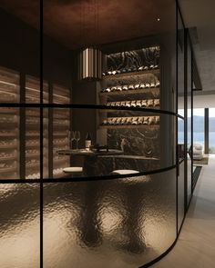 the interior of a modern bathroom with glass walls and marble counter tops, along with an ocean view