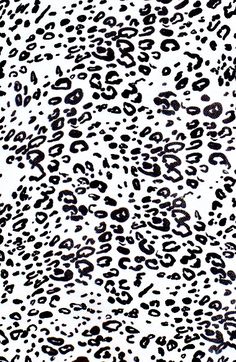 an animal print fabric with black and white spots