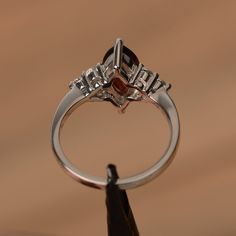 It is a natural garnet ring. The main stone is 7mm*12mm marquise cut, weight about 2.25 carats. The basic metal is sterling silver and plated with rhodium. To change the metal to a solid gold (white/rose) or platinum is also available, please ask for a quotation if you want. You can also go to my shop Home for more elegant rings: https://www.etsy.com/shop/godjewelry?ref=hdr_shop_menu More garnet rings: https://www.etsy.com/shop/godjewelry?section_id=20709242 Customization is always welcome and p Silver Marquise Ruby Ring For Anniversary, Silver Marquise Cut Ruby Promise Ring, Ruby Birthstone Ring Marquise Cut For Anniversary, Ruby Marquise Cut Birthstone Ring For Anniversary, Marquise Cut Ruby Birthstone Ring For Anniversary, Anniversary Ruby Birthstone Ring With Marquise Cut, Silver Marquise Ruby Ring, Marquise Garnet Ring For Anniversary, Silver Marquise Birthstone Ring For Anniversary