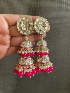 If you love Jhumkas, these earrings with double jhumkas are the perfect pair for your next traditional outfit! Wedding Bridesmaid Outfit, Pink Jhumka, Kundan Jhumkas, Festival Jewellery, Earrings Kundan, Hot Pink Earrings, Indian Festival, Kundan Earrings, Festival Jewelry