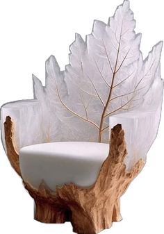 a white vase sitting on top of a tree stump with leaves in it's center