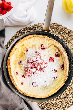 a pancake with powdered sugar and cranberries in it