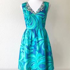 Lilly Pulitzer Excellent Used Condition Cocktail Dress, Fit And Flare With Pockets Sparkly Material But Very Comfortable. V-Neck Fall Or Winter Print With Blue And Green Pattern. Perfect For A Florida Fall Or Winter Event Questions? Leave A Comment Below! Cocktail V-neck Dress With Rhinestones, Cocktail Dresses With Rhinestones And V-neck, Summer V-neck Dress With Rhinestones, Florida Fall, Low Cut Dress, Low Cut Dresses, Winter Event, Cut Dress, Winter Print