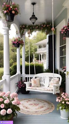 a white porch swing with pink flowers and potted plants hanging from it's sides