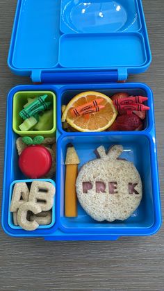 a blue lunch box filled with food on top of a table