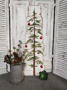 a small christmas tree sitting next to an old door