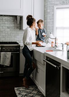 a mother and son are in the kitchen preparing food for their child to cook on the stove