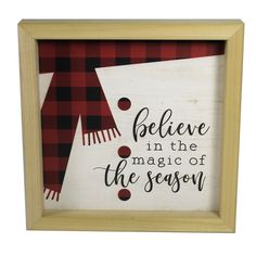 a wooden framed sign that says believe in the magic of the season