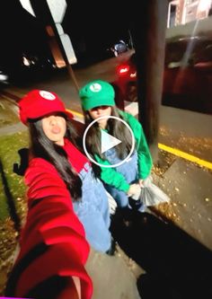 two women are sitting on the curb at night