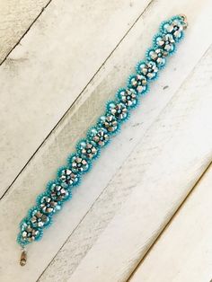 "This bracelet is a beauty and would be the perfect gift for Mother's Day or any other special occassion.  It's loaded with blue 6mm rounds beads, 4mm silver bicones and shiny blue seed beads.  It has a snap type closure.  Although it is 8\" long, it will only fit up to a 7\" wrist unless extra links are added.   This is my adaptation of designer Deborah Farrand's design called X's and O's Bracelet." Blue Crystal Bracelet With Silver Beads, Blue Beaded Bracelets With 8mm Beads For Party, Blue Bracelets With 8mm Beads For Party, Blue Beaded Bracelets With Spacer Beads For Party, Blue Beaded Bracelets For Party, Party Bracelet With Turquoise Faceted Beads, Party Bracelets With Turquoise Faceted Beads, Turquoise Bracelets With Faceted Beads For Party, Party Turquoise Bracelets With Faceted Beads