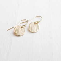 "Petite Gold hammered discs - They fall just under half an inch from their goldfill hooks, these minimalist earrings feature hammered goldfill circles. Perfect for the pickiest jewelry wearer on your gift list. Rubber ear clutches are included to prevent loss. . { m e a s u r e m e n t s } . 1/3\" discs . { o p t i o n s } . Also available in silver: http://www.etsy.com/listing/174891529/organic-hammered-circle-earrings In rose gold: http://www.etsy.com/listing/176380506/everyday-earrings-rose-g Hammered Minimalist Adjustable Earrings, Adjustable Hammered Minimalist Earrings, Minimalist Hammered Adjustable Earrings, Simple Hammered Everyday Earrings, Dainty Adjustable Hammered Earrings, Simple Everyday Hammered Earrings, Adjustable Hammered 14k Gold Earrings, Everyday Hammered 14k Gold Filled Earrings, Dainty Hammered Brass Earrings