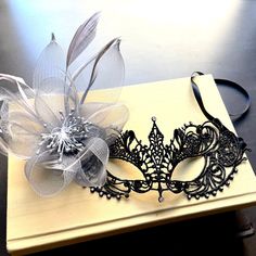 The black lace mask is accentuated by the decoration of gray floral highlighting its individuality. Black Masquerade Mask For Halloween Wedding, Black Masquerade Mask For Wedding Carnival, Black Wedding Headpiece For Carnival, Elegant Halloween Masquerade Headpieces, Elegant Black Costume Accessories For Wedding, Black Masquerade Mask Women, Black Lace Mask, Mascarade Party, Masquerade Mask Women