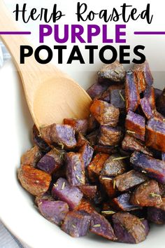 roasted purple potatoes in a white bowl with a wooden spoon and text overlay that reads, here is roasted purple potatoes