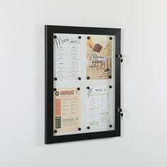 a black framed menu hanging on the wall