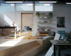 a living room filled with furniture and lots of windows