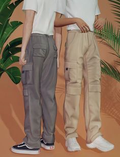 two men standing next to each other in front of a palm leaf covered wall, both wearing white shirts and khaki pants