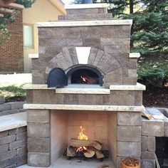 an outdoor pizza oven with logs in it