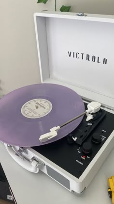 an old record player sitting on top of a table