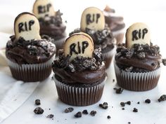 cupcakes decorated with chocolate frosting and sprinkles that spell out rip