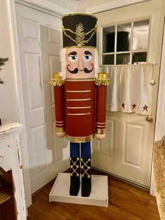 a large nutcracker standing in front of a door