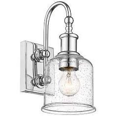 a light fixture with a clear glass shade on the front and back of it's arm