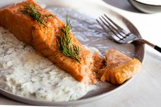 a plate topped with salmon and cream sauce