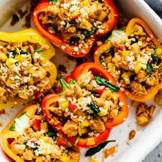 stuffed bell peppers in a white casserole dish