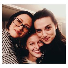 three women are posing for the camera with their arms around each other