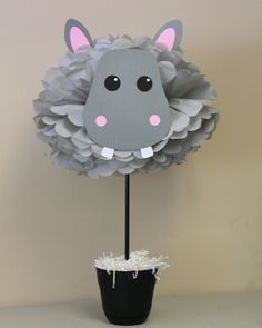 a paper sheep head on top of a cake