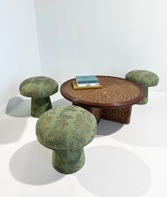 three stools and a table with a book on it