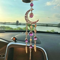 a car dashboard with a wind chime hanging from it's side