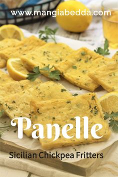 some sliced up lemons and parsley on top of a cutting board with the words panelle written in white