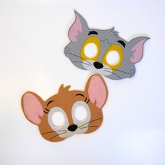 two felt masks with different colored eyes and ears, one grey cat and the other brown mouse