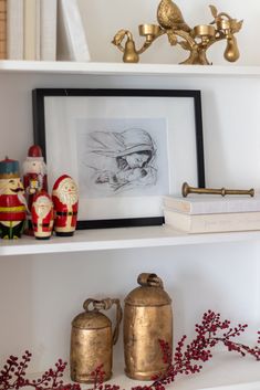 a shelf filled with books and figurines on top of it