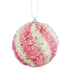 a pink and white ball ornament hanging from a string on a white background