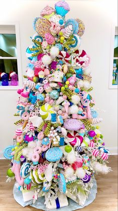 a brightly colored christmas tree with lots of ornaments on it's top and bottom