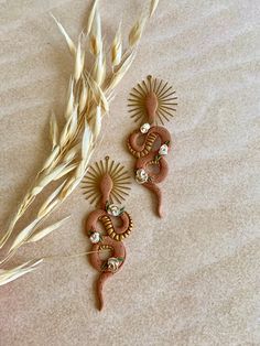 two decorative items are laying on the floor next to some dry grass and wheat stalks