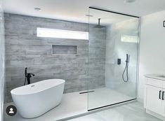 a white bath tub sitting next to a walk in shower