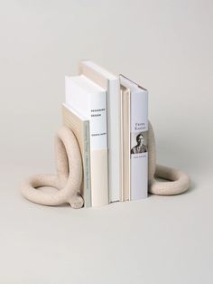 two bookends made out of books and one is shaped like a snake