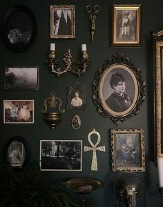 there are many pictures on the wall with candles and other things to put on it