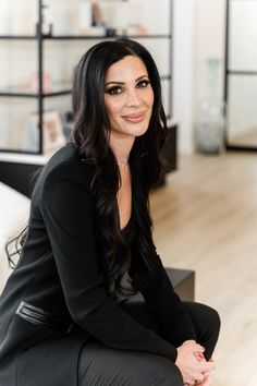 a woman sitting on top of a wooden floor