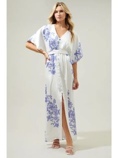 An effortless kimono frame with dolman sleeves that highlight a button front. A sash style belt wraps around the waist to add shape. - Lined - Functional buttons - Belt - Dolman sleeve - Color: White Cobalt Kimono Maxi Dress, Floral Kimono, Floral Motifs, White Maxi Dresses, New Arrival Dress, Dolman Sleeve, Floral Maxi Dress, Floral Motif, Blue Floral